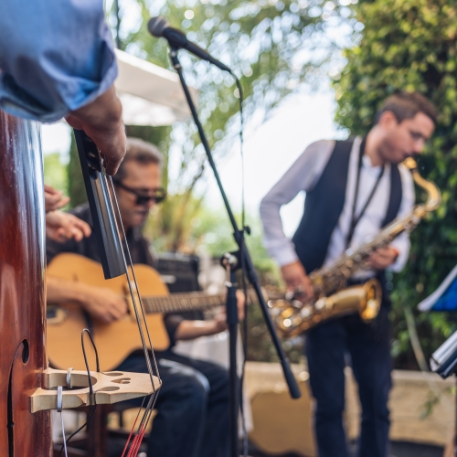 Live outdoor band performing with guitar, saxophone, and bass at The Shops at Marley Park.
