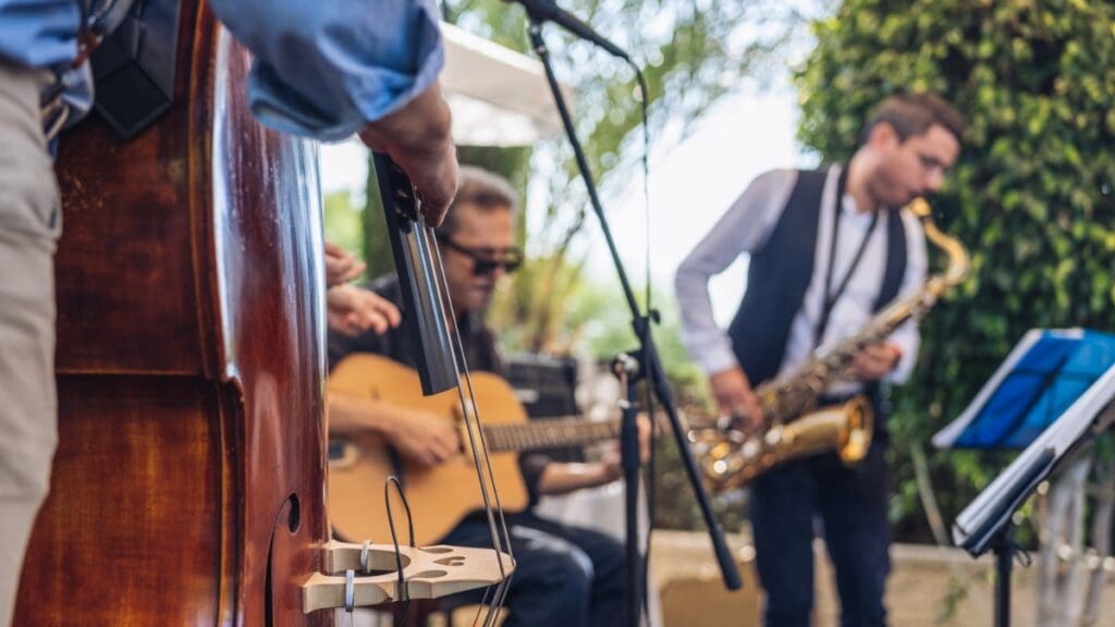 Live band performing outdoors at Marley Park (guitar and saxophone).
