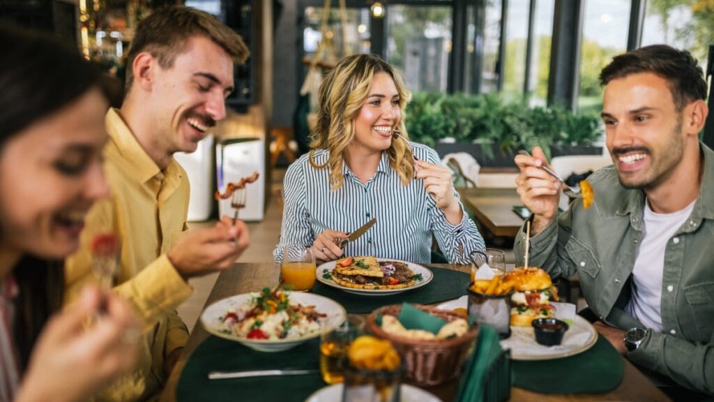 Group of people enjoying lunch together at an outdoor restaurant in Marley Park.