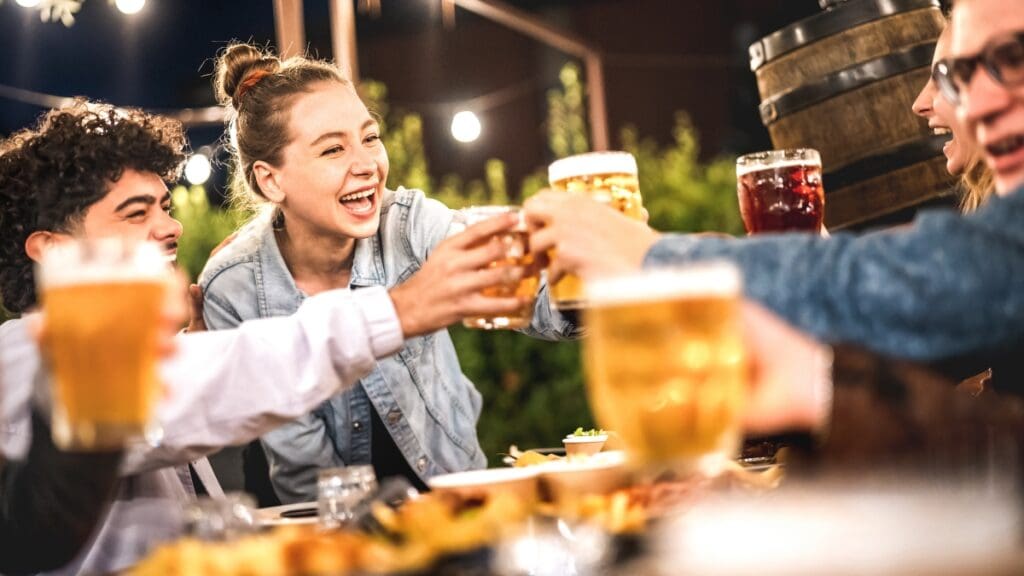 Friends enjoying drinks at an outdoor restaurant at The Shops at Marley Park.