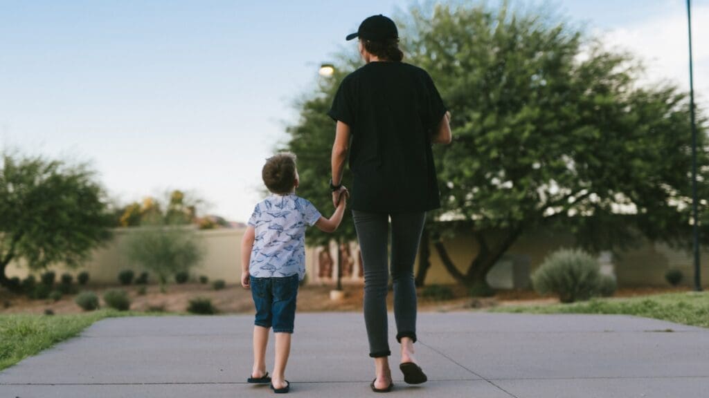 Mother and son walking along landscaped pathways at The Shops at Marley Park.